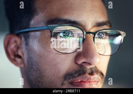 Glasses, man and reflection of programmer on computer working on software, code and data. IT, engineer and serious face of developer with information Stock Photo