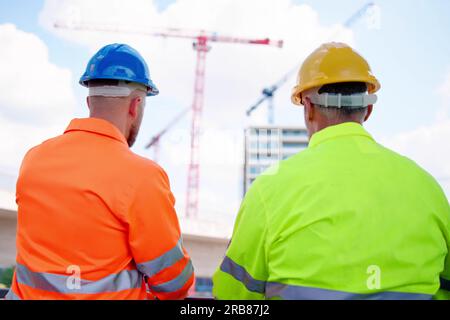 OSHA Inspector At Construction Site. Engineer Workers Stock Photo