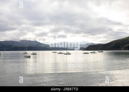 Akaroa is a small town on Banks Peninsula in the Canterbury Region of the South Island of New Zealand, situated within a harbour of the same name Stock Photo