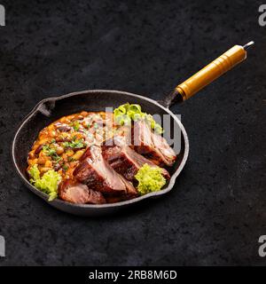 Bean stew with smoked and roasted pork hock slice Stock Photo