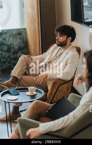 Handsome male business person thinking deeply about something while taking a break from work Stock Photo