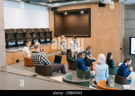 Multiracial, inter-generational, group of creative businesspeople discussing new business ideas at work Stock Photo