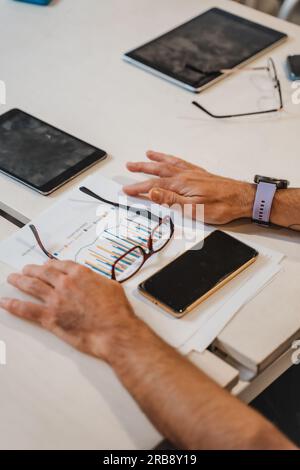 Documents on table. Sunglasses over documents. Phone over documents. Close up shot Stock Photo