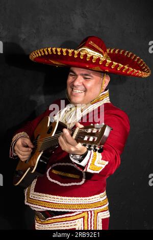 Mexican musician mariachi plays the guitar on a city street. Stock Photo