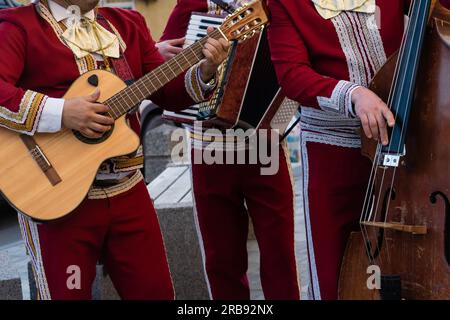 Mexican musician mariachi plays the guitar on a city street. Stock Photo