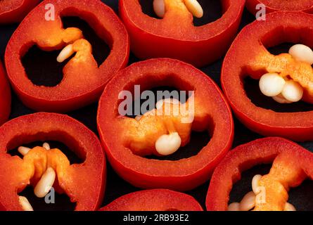 close up of cut red hot chili peppers, Capsicum isolated on black background. sliced red hot chili peppers. high-quality studio shot of red  capsicum. Stock Photo