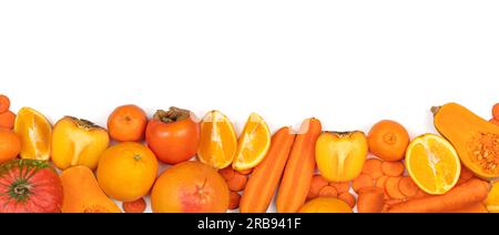 Panoramic set of ripe, juicy orange color fruits and vegetables on white background with copy space. Carrot, orange, persimmon, pumpkin, mandarin, gra Stock Photo