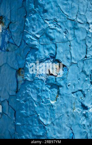 Rust on a blue surface. Cracks in the paint. Old iron. Rusty stains on metal. Background water column Stock Photo