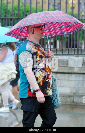 London, UK. 8th June, 2023. Crowds out in the West End outside the Houses of Parliament despite heavy showers. Credit: JOHNNY ARMSTEAD/Alamy Live News Stock Photo