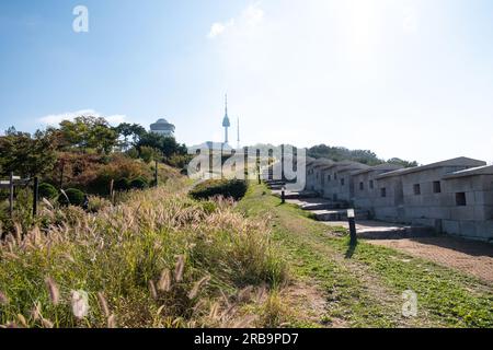 Walkway next to Hanyangdoseong Wall or Seoul City Wall in Namsan park, with the view of N Seoul Tower. South Korea Stock Photo