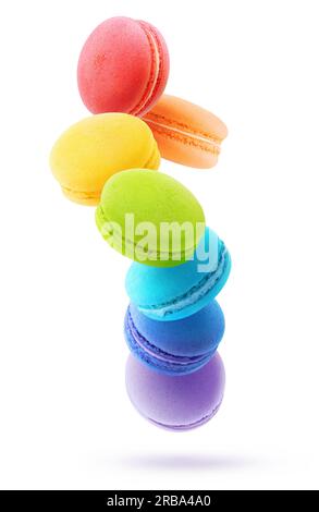 Rainbow coloured macaroons levitation, vertical shot isolated on white background Stock Photo