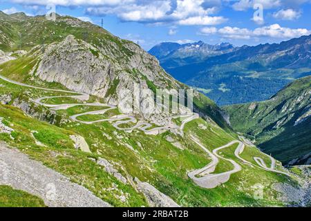 View from elevated position on old southern pass road Tremola south ramp with serpentines tight curves hairpin bends on steep mountain slope of Stock Photo