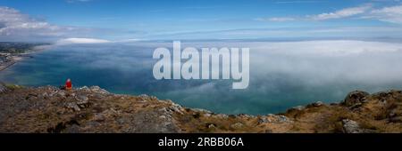 View from the summit of Bray Head with sea mist rolling over the coastline Stock Photo