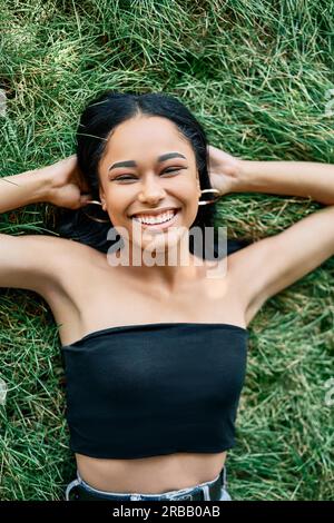 https://l450v.alamy.com/450v/2rbb0ab/top-view-portrait-of-pretty-happy-afro-american-woman-relaxing-on-grass-in-park-rest-female-beauty-concept-2rbb0ab.jpg