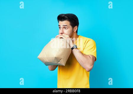 Young handsome man having a panic attack on blue background Stock Photo