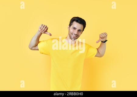 Photo of handsome young man pointing to himself isolated over yellow background Stock Photo