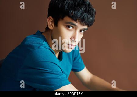 Portrait of young handsome man posing on studio bsckground looking to camera. man beauty concept Stock Photo