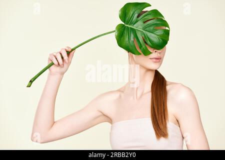 Faceless concept Beautiful young woman with chrysantemas bouquet