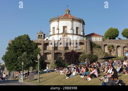 Park Jardim do Morro with view of Serra da Pilar, many people sitting on the lawn, Vila Nova de Gaia, Porto region, Portugal Stock Photo