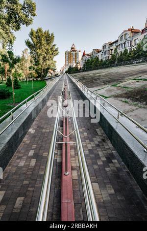 A long metal ramp for handicapped people, bicycles and people with strollers, near Natalka Park in the Obolon district of Kiev, Ukraine Stock Photo