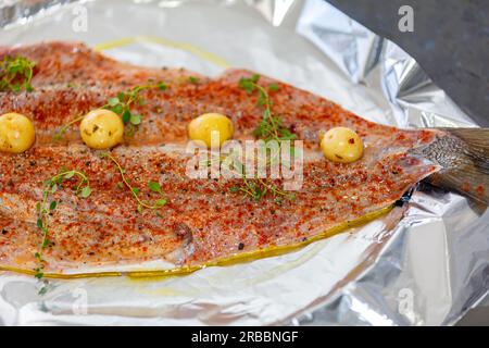 Traditional anchovy fish (Pomatomus saltador) seasoned ready to be baked in the oven Stock Photo