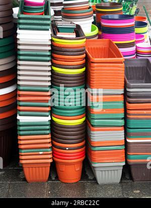 Stack of empty plastic flower pots sold on market place Stock Photo