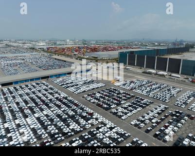Aerial view of new cars stock at factory parking lot. Above view cars parked in a row. Automotive industry. Logistics business. Import or export new Stock Photo