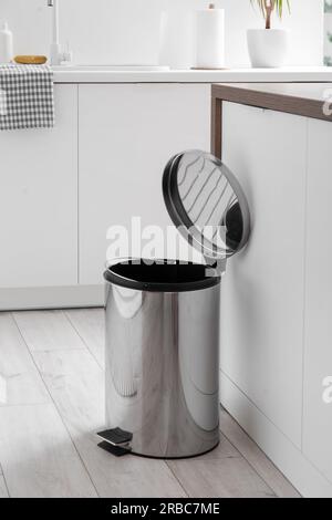 Opened trash bin in interior of light kitchen Stock Photo
