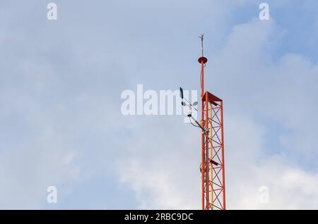 Power pole with wires for power transmission, cloudy skies of winter (for the editor - on the sign in Hebrew - danger of death, high voltage) Stock Photo