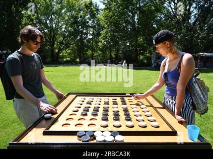 Berlin, Germany. 8th July, 2023. People play a board game during the cultural festival 'Culture meets Garden' at the Gardens of the World in Berlin, Germany, on July 8, 2023. The festival was held here from Saturday to Sunday. Credit: Ren Pengfei/Xinhua/Alamy Live News Stock Photo