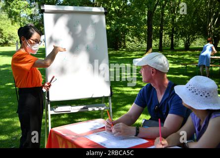 Berlin, Germany. 8th July, 2023. People learn Chinese during the cultural festival 'Culture meets Garden' at the Gardens of the World in Berlin, Germany, on July 8, 2023. The festival was held here from Saturday to Sunday. Credit: Ren Pengfei/Xinhua/Alamy Live News Stock Photo