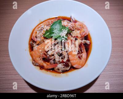 fresh braised shrimps with green vegetables and sesame in red spicy oil sauce Stock Photo