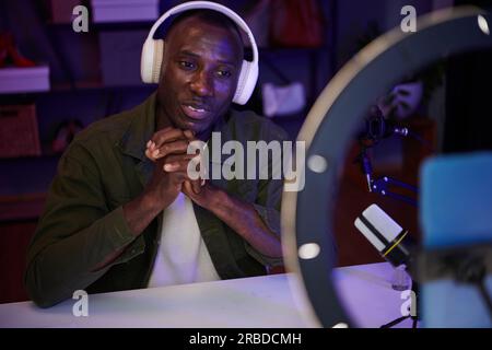 Black man in headphones filming video for his channel Stock Photo