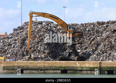 Large yellow crane at scrap yard Stock Photo