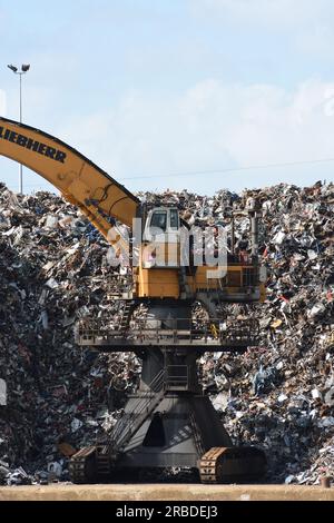 Large yellow crane at scrap yard Stock Photo