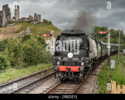 A steam engine approaches Corfe Castle Railway Station. The award winning Swanage Railway Company is volunteer-led and runs between Wareham and Swanag Stock Photo