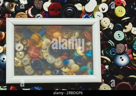 White blur frame on scattered different buttons of a tailor in a shop Stock Photo