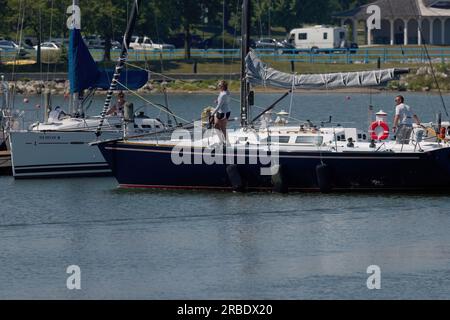 Manitowoc, WI July 08 2023. Sailboat returning from Lake Michigan arrives in harbor in Manitowoc Stock Photo