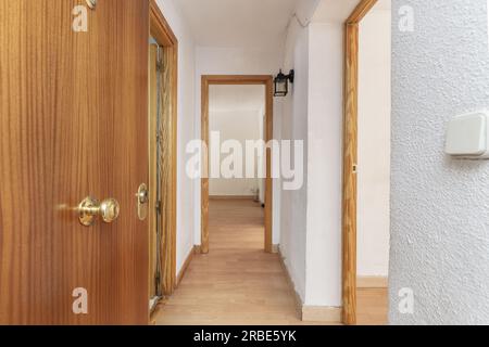 An empty room with several pine wood doors with windows and weathered ...