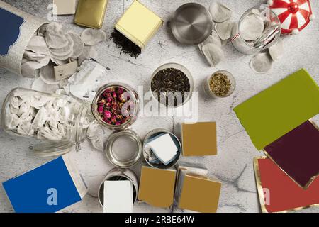 A still life with tea bags in glass jars, tins with lids, loose tea bags, tea in tins Stock Photo