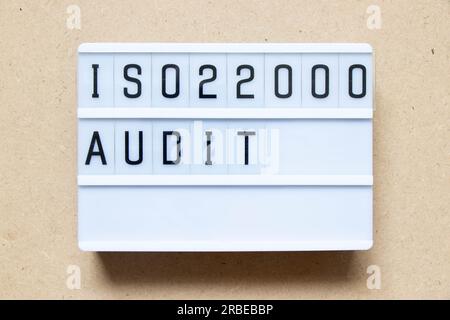 Lightbox with word ISO 22000 audit on wood background Stock Photo