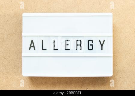 Lightbox with word allergy on wood background Stock Photo