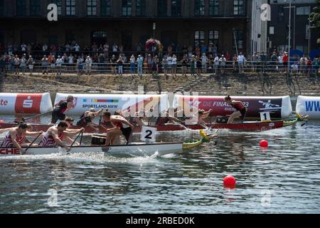 The boat of the Neckardrachen Heilbronn, winner, gold medal, finish in front of the boat Roter Drache Muelheim, 2nd place, silver medal, action, final dragon boat mixed, canoe parallel sprint, canoe competitions on July 9th, 2023 in Duisburg/ Germany. The finals 2023 Rhine-Ruhr from 06.07 - 09.07.2023 Stock Photo