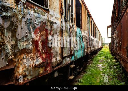 Perpective shot of old damaged trains and wagons, vintage background very shallow depth of field Stock Photo