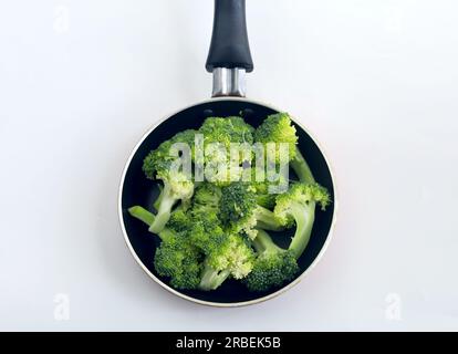 Healthy Green Organic Raw Broccoli ready to cook. Raw broccoli at frying pan Stock Photo