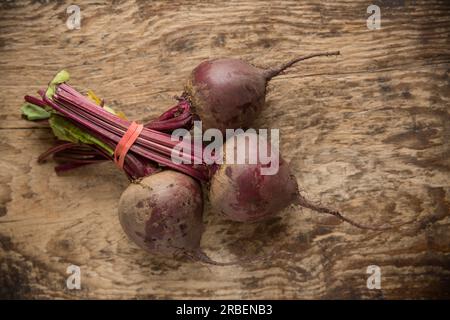 Three whole raw beetroot from a supermarket in the UK that will be used to make Borscht soup. England UK GB Stock Photo
