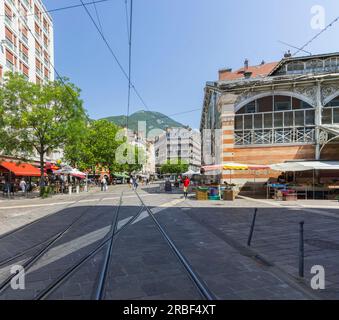 Grenoble, France - July 8, 2023: From Rue Alphand, Place Sainte Claire and Halles-Sainte Claire. Les Halles Sainte-Claire (architect Hector Riondel, 1 Stock Photo