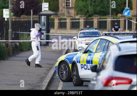 A forensics photographer on Portsmouth Road in Long Ditton, south west London, after two people were stabbed in Surbiton. One person is believed to have been assaulted at the Crowne Plaza Hotel in Portsmouth Road, while the other man was attacked at the BMW garage next door. Both victims were rushed to hospital after being stabbed on Sunday at around 1.45pm. A man has been arrested on suspicion of attempted murder. Picture date: Sunday July 9, 2023. Stock Photo