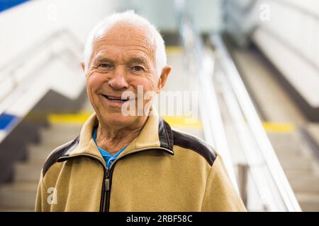 Portrait of old man going to metro station Stock Photo