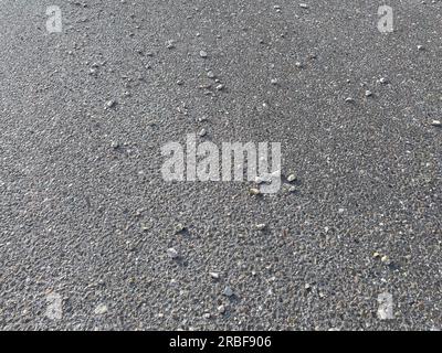 Stones on asphalt. Grey texture. Stock Photo